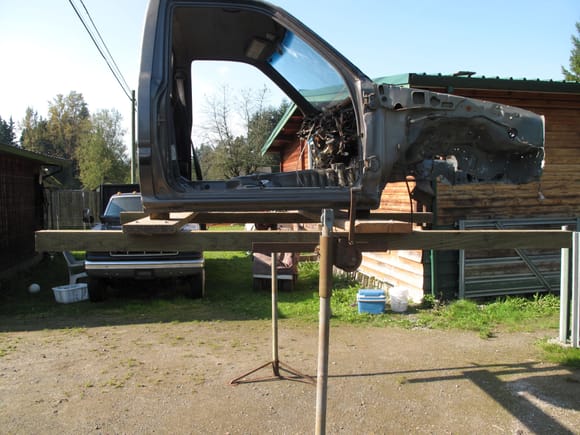 This is my Redneck cab hoist, I made it from an old set of camper jacks and some  4x4’s and planks.
I would not rent this rig out, or recommend or imply that it is safe.