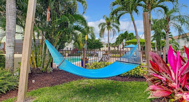 Drift away in a blissful slumber, nestled in the poolside hammock garden under swaying palms.