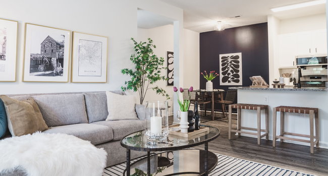 Renovated apartment home featuring an open floor plan, comfortable seating, and stylish cabinetry